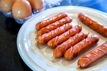 Grilled sausages on table