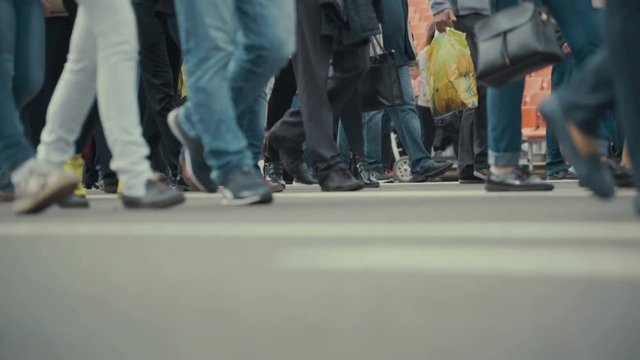 People pedestrians walks across a busy city street.