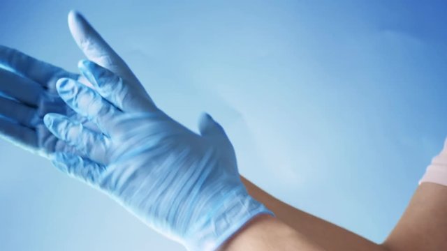 Doctor take off blue latex gloves