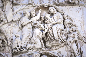 Detail of the facade of the Duomo of Orvieto, Italy. Marble bas-relief representing episodes of the bible. Adoration of the Magi
