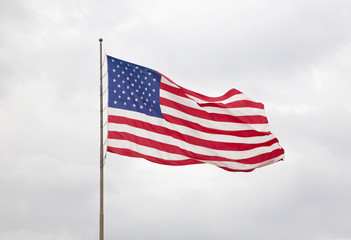 American Flag with a Blue Cloudy Sky