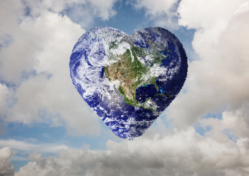 Heart shaped earth against blue sky with white clouds