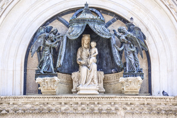 Detail of the facade of the cathedral of Orvieto, Umbria, Italy. Marble statue of the Virgin Mary