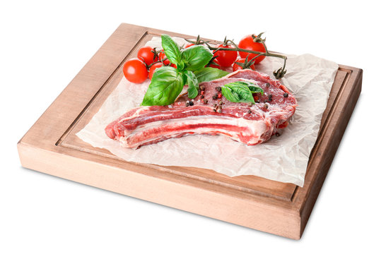 Wooden board with fresh raw pork rib isolated on white