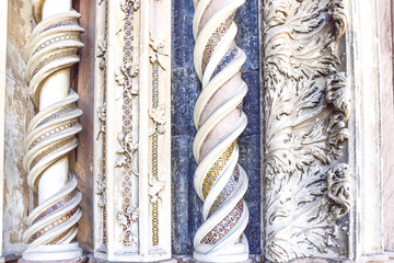 Detail of the facade of the cathedral of Orvieto, Italy. Spiral marble columns decorated with...