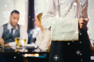 Waitress standing in front of two business people talking against snow falling