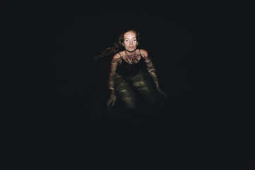 Fototapeta na wymiar Woman swimming in the dark