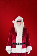 Santa Claus wears black sunglasses  against red background