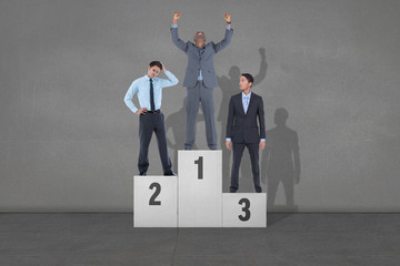 Composite image of business people on podium against black wall