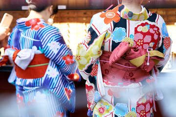 Young girl wearing Japanese kimono standing in front of Sensoji Temple in Tokyo, Japan. Kimono is a Japanese traditional garment. The word 