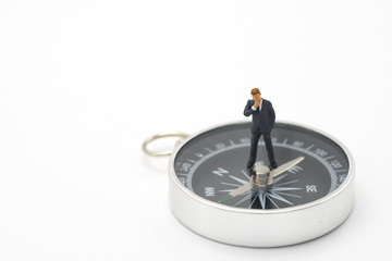 Miniature people businessmen analyze standing on compass as background strategy concept and...