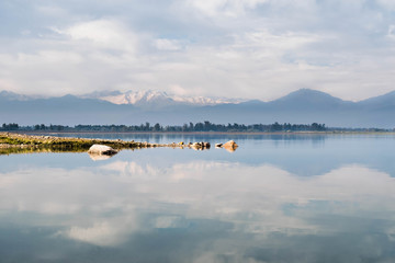 Symmetrical cloudy sky reflection in the water surface of Convento Viejo Dam in Chile, VI region near Chimbarongo and San Fernando