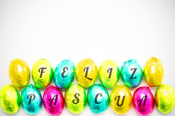 feliz pasqua against colourful foil wrapped easter eggs