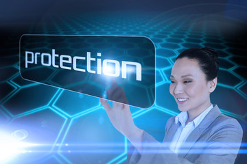 Businesswoman pointing to word protection pointing against black background with shiny hexagons