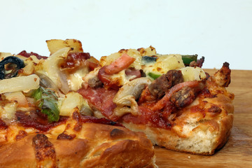 Pizza beef chicken peperoni cheese chilli capsicum onion olive on wooden board