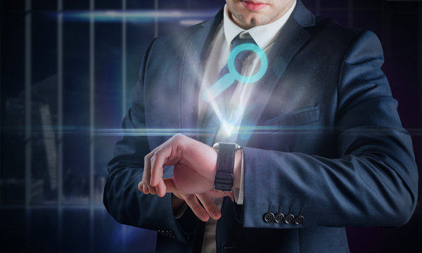 Composite image of businessman using hologram watch against office overlooking city at night