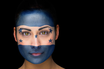 Composite image of honduras football fan in face paint against black