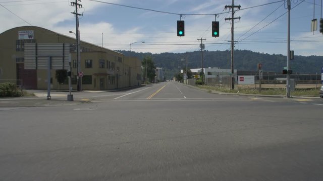 Front view of a Driving Plate: Car travels on NW Nicolai Street in Portland, Oregon, turns left onto NW 24th Avenue, left onto NW York Street, and continues for several blocks though an industrial warehouse area before turning left onto NW 21st Avenue. It continues on NW 21st to the intersection at NW Front Avenue.