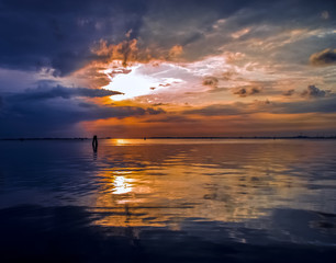 Colorful sunset sky reflecting in water