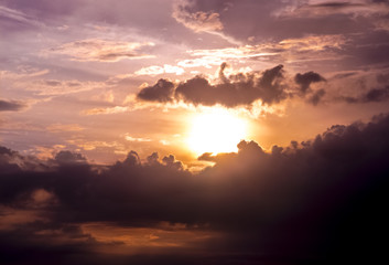 Sun going down in cloudy sky