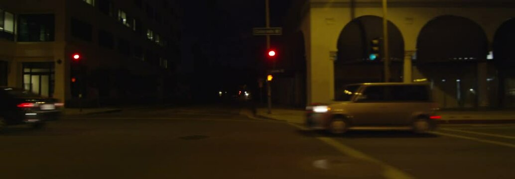 Left Side view of a Driving Plate: Car travels on East Colorado Boulevard in Pasadena, California at night, crossing North Wilson Avenue and continuing to North Meredith Avenue.