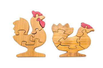 Jigsaw puzzles, wooden pieces and chicken shapes Made of small pieces of wood on a white background to train and develop children.