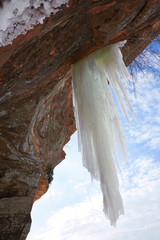 Giant icicle hanging from rock near Lake Superior in Wisconsin, USA