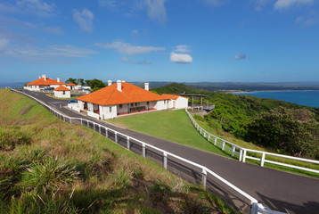 Picturesque red-roofed houses near Cape Byron Lighthouse at Byron Bay, NSW, Australia
