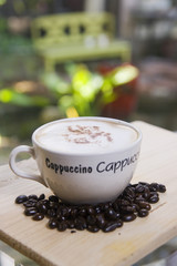 Cappuccino coffee cup and coffee beans