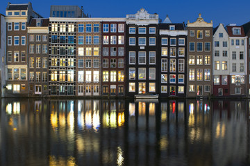 Amsterdam, night view of ancient houses on Amstel river.
