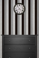 black wooden cabinet and clock in empty room with black and white wallpaper. vintage style