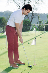 Fototapeta premium Man playing golf is going to hit ball at golf course