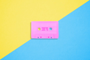 Retro cassette tapes on a bright duotone background.