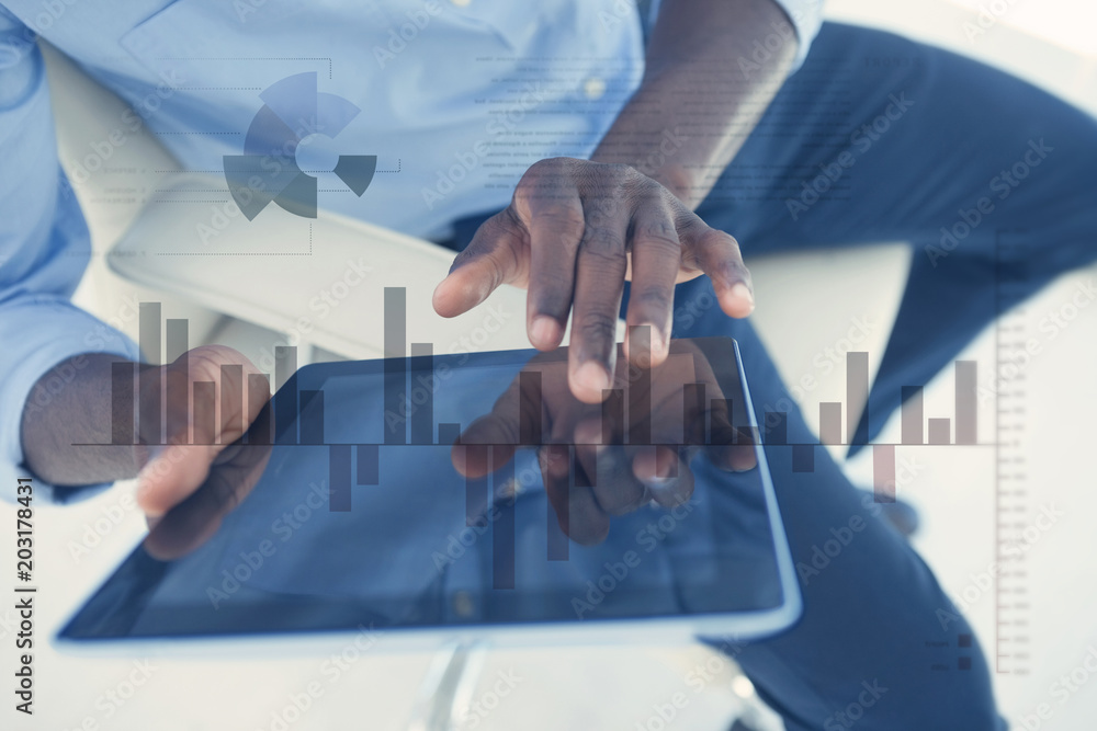 Poster business interface with graphs and data against businessman using digital tablet while sitting on ch