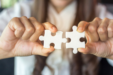 Businessman hands connecting jigsaw puzzle. Business solutions, success and strategy, learning concept.