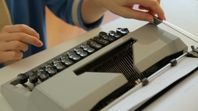 Female hands typing on typewriter