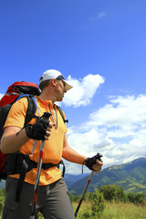 Summer hike in the mountains with a backpack and tent.