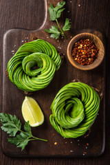 toast with avocado roses on wooden cutting board