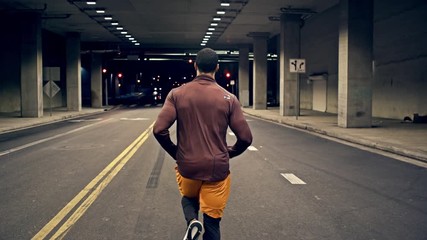 Athletic male running through on of the tunnels that go under Los Angeles. Slow Motion.
