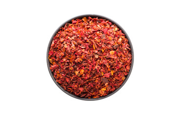 dried tomato powder in clay bowl isolated on white background. Seasoning or spice top view