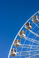 Ferris wheel on a blue sky background.