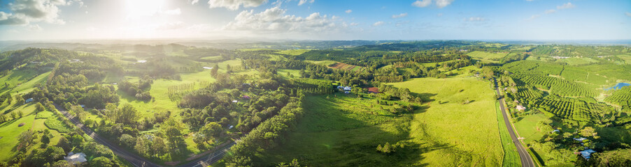 Wide aerial panorama of beautiful green Australian countryside at sunset