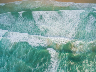 Powerful waves crushing on a beach - aerial view