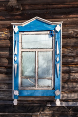 frozen window in old wooden rural house in winter