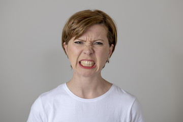 human expressions and emotions. Young attractive woman with an angry face, looking furious and crazy