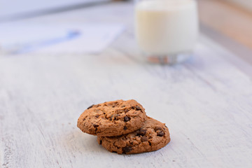 Chocolate chips cookies/ American cookies/ and healthy glass of milk at light wooden background/ Healthy morning