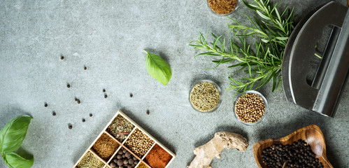 A collection of fresh spices on a gray stone table