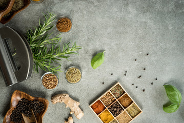 A collection of fresh spices on a gray stone table