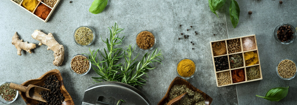 A collection of fresh spices on a gray stone table