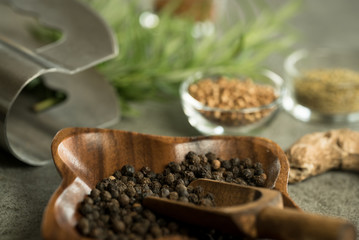 A collection of fresh spices on a gray stone table